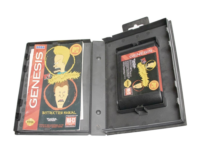May include: A black Sega Genesis game cartridge case with a black and red game cartridge inside. The game cartridge is for the "Beavis and Butt-Head" video game. The case has a label that says "GENESIS" and "VIACOM". The instruction manual is included and has a picture of Beavis and Butt-Head on the cover.