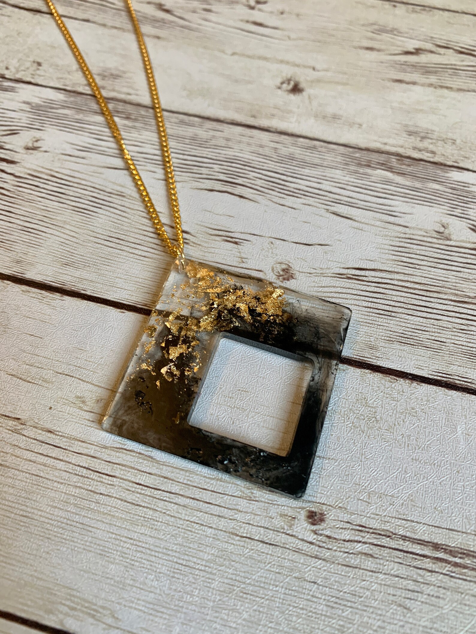 Black and gold resin pendants with gold leaf accents and 20 Etsy