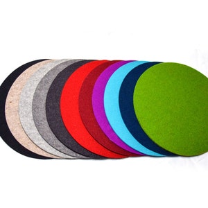 May include: A set of ten round felt coasters in various colours, including beige, grey, black, red, purple, blue, and green.