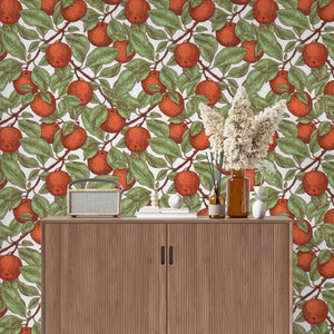 May include: A wooden cabinet with two doors and a white background featuring a repeating pattern of orange fruit and green leaves.