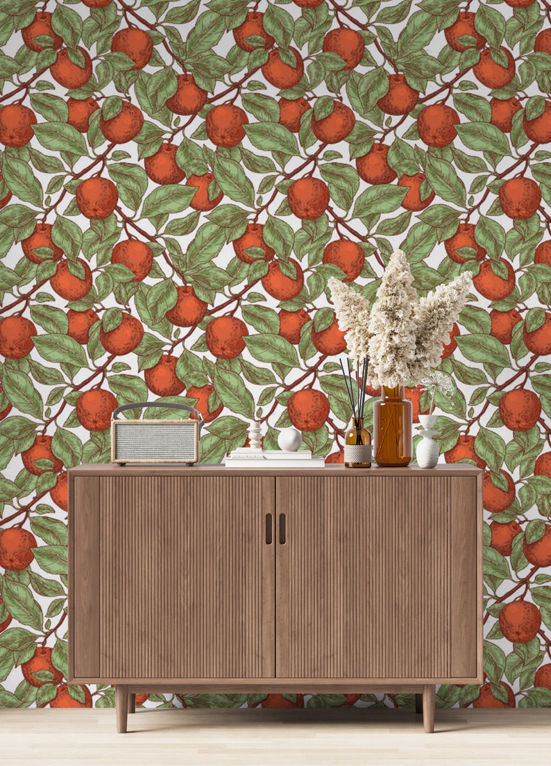 May include: A wooden cabinet with two doors and a white background featuring a repeating pattern of orange fruit and green leaves.