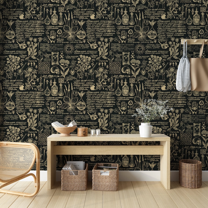 May include: Black and gold wallpaper with a repeating pattern of botanical illustrations, including plants, flowers, and vials. The wallpaper is displayed in a room with a wooden table, a wicker chair, and a potted plant.