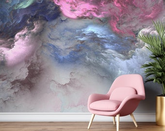 May include: A pink armchair with wooden legs is positioned on a wooden floor, in front of a wall mural. The mural depicts a swirling cloud design in pink, blue, and grey. A potted plant with green leaves is to the right of the chair.