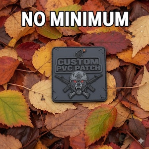May include: A square, gray PVC patch with the text "CUSTOM PVC PATCH" and a bear graphic with crossed rifles. The patch is set against a backdrop of colorful autumn leaves, with the words "NO MINIMUM" at the top.