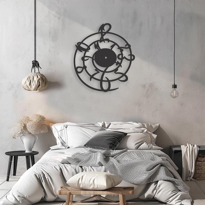 May include: Black metal wall art featuring a treble clef design with a circular shape. The art is displayed on a white wall above a bed with white bedding and a gray throw blanket.