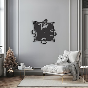 May include: A black metal wall clock with a square frame and a unique design. The numbers are stylized and appear to be floating around the clock face.