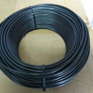 May include: A coil of black electrical wire, tightly wound and ready for use in a variety of electrical projects.