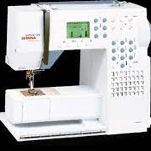 以下が含まれることがあります： デジタルディスプレイとさまざまなボタンやダイヤルを備えた白いミシン。ミシンには針と糸が取り付けられており、右側にフットペダルが見えます。