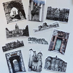 May include: A collection of black and white architectural stickers featuring various buildings, arches, and monuments. The stickers showcase detailed pen and ink illustrations of historical landmarks and cityscapes, perfect for decorating notebooks or scrapbooks.