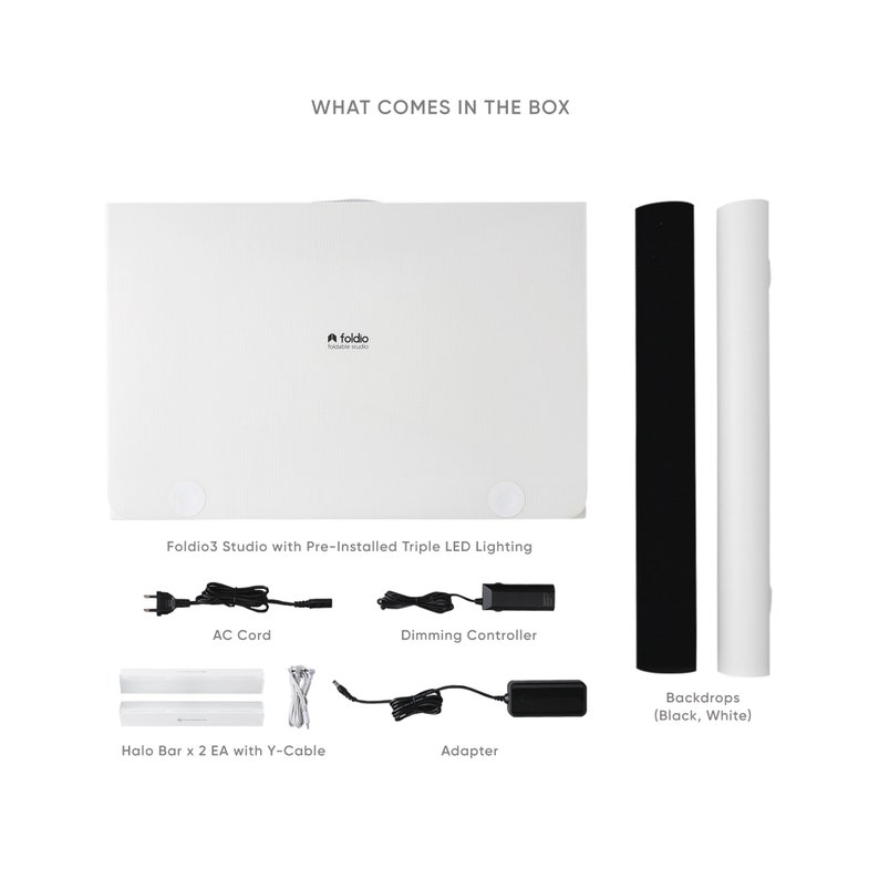 May include: A white Foldio3 Studio with pre-installed triple LED lighting, two backdrops (black and white), an AC cord, a dimming controller, and an adapter. The studio is a portable photography lightbox.