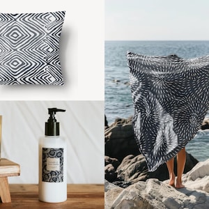 May include: A set of home decor items featuring black and white geometric patterns. The set includes a throw pillow, a fabric scarf, a candle, and a bottle of hand soap.