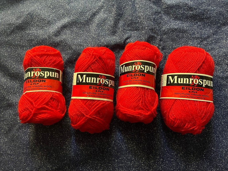 May include: Four balls of red yarn labeled "Munrospun Eildon 4 Ply 100% Pure Virgin Wool Made in Great Britain."