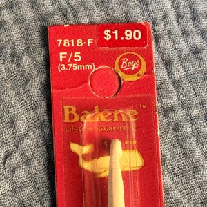 May include: A red package containing a white crochet hook. The package has the text "7818-F F/5 (3.75mm)" and the Boye logo. The package also has the text "Badene Lifetime Guarantee".