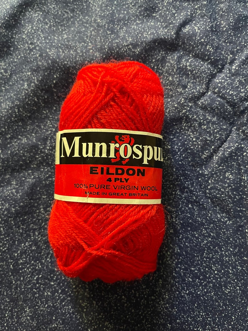 May include: A ball of red yarn labeled "Munrospun Eildon 4 Ply 100% Pure Virgin Wool Made in Great Britain".