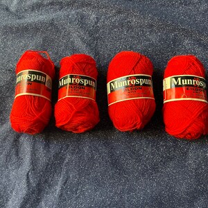 May include: Four balls of red yarn labeled "Munrospun Eildon 4 Ply 100% Pure Virgin Wool Made in Great Britain"