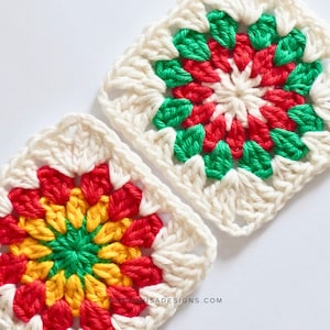 May include: Two square crochet pieces with a floral design. The center of each square is red, yellow, and green, surrounded by white yarn. The crochet work is detailed and the squares are set against a white background.