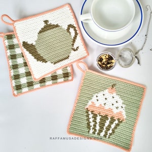 May include: Three crocheted pot holders with a peach border. One pot holder features a green teapot, another features a green and white checkered pattern, and the third features a green cupcake with white frosting and a pink cherry.