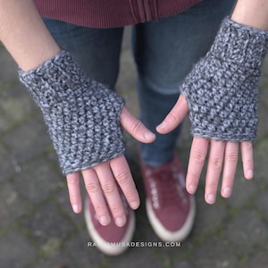 May include: A pair of gray crocheted fingerless gloves with a textured stitch pattern.