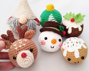 May include: A set of six crocheted Christmas ornaments, including a snowman, a reindeer, a gnome, a Christmas tree, a pudding, and a gingerbread man. The ornaments are all white, brown, green, and red.