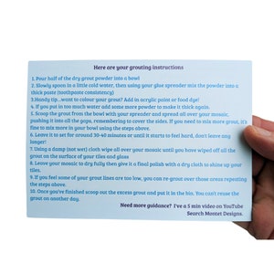 May include: A white card with blue text outlining instructions for grouting a mosaic. The card includes a handy tip for adding color to the grout and a suggestion to watch a 5-minute video on YouTube for more guidance.