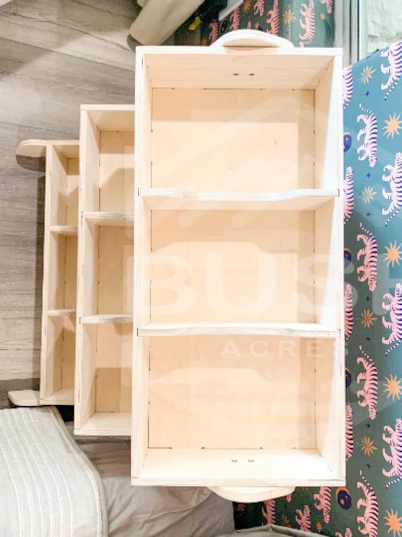 May include: A set of three wooden shelves with a natural finish. The shelves are stacked on top of each other and have a simple design. The shelves are empty and ready to be filled with items.