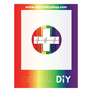 May include: A rainbow-colored enamel pin with a white cross and a heartbeat symbol inside. The pin says "Dental DIY" at the bottom and "www.dentaldiyshop.com" at the top.