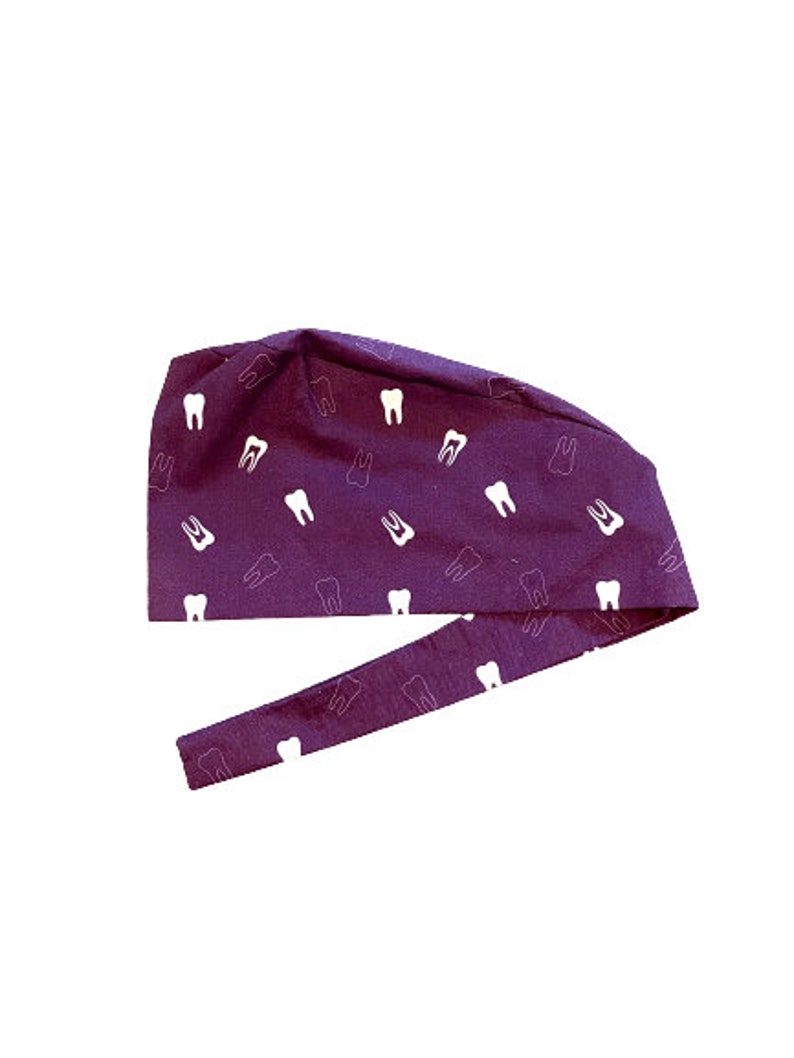 May include: Purple surgical scrub hat with a white tooth pattern.