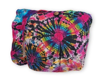 May include: A colourful tie-dye fabric tote bag with a wooden button closure. The bag has a long strap and is ideal for carrying everyday essentials.