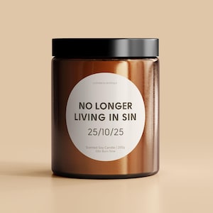 May include: A brown glass jar candle with a white label that reads "LUSTROUS CRYSTALS NO LONGER LIVING IN SIN 25/10/25 Scented Soy Candle | 200g 33hr Burn Time"