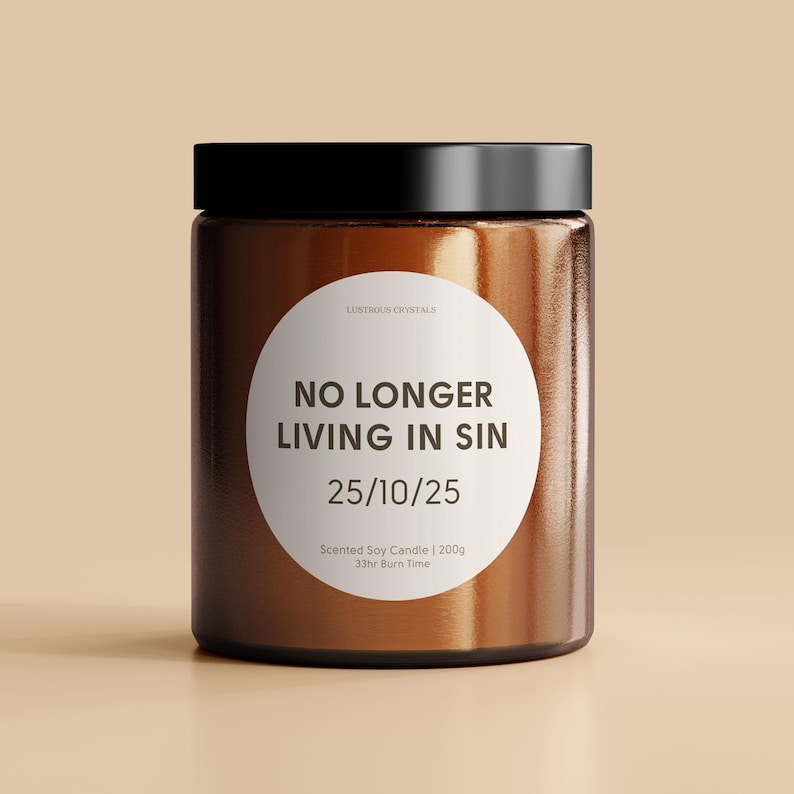 May include: A brown glass jar candle with a white label that reads "LUSTROUS CRYSTALS NO LONGER LIVING IN SIN 25/10/25 Scented Soy Candle | 200g 33hr Burn Time"