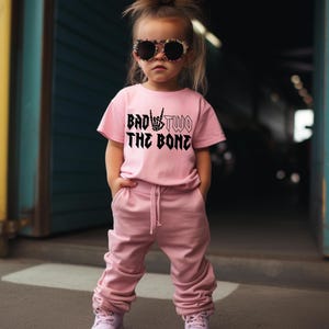 Bad Two The Bone 2nd Birthday Shirt Rock On Skeleton Hand Toddler Girls Pink Tee