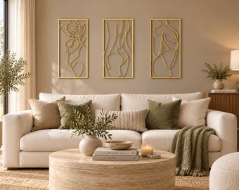 May include: A set of three rectangular wall art pieces featuring gold-toned wire outlines of human figures. Each piece is framed in a thin gold border, showcasing continuous line art designs that depict abstract silhouettes of the human form.