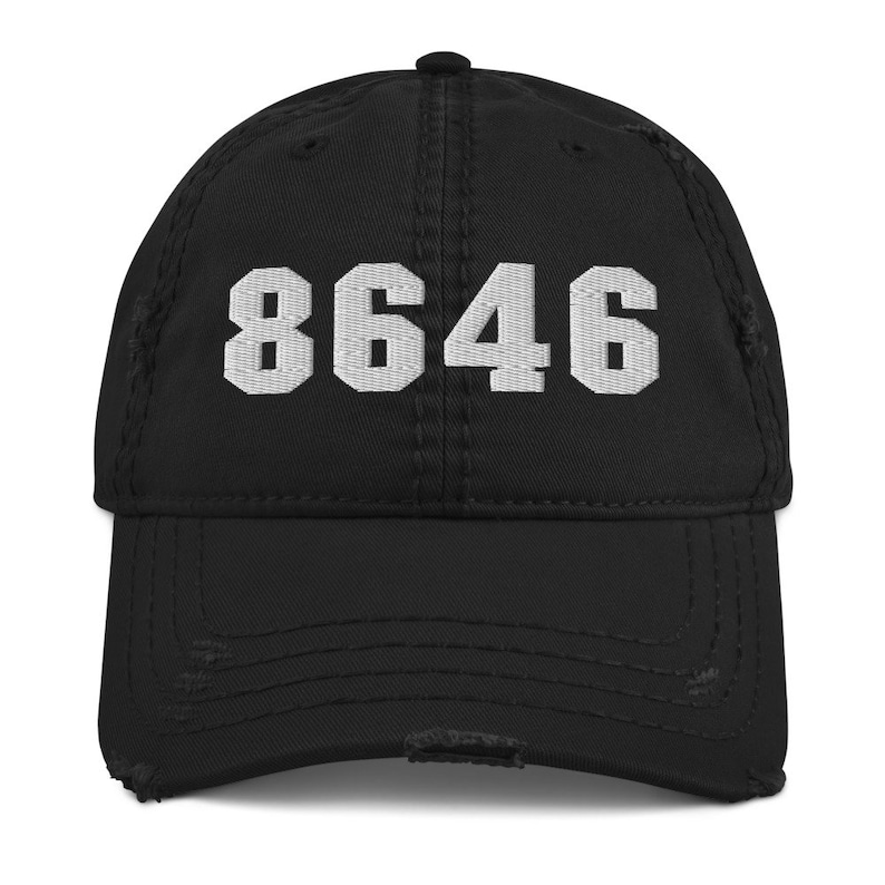 May include: Black distressed baseball cap with white embroidered text "8646".