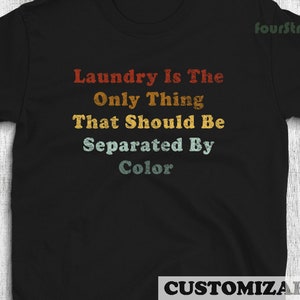 May include: Black t-shirt with a vintage-style graphic that reads "Laundry is the only thing that should be separated by color."