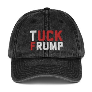 May include: A black vintage washed cotton baseball cap with the words "TUCK FRUMP" embroidered in red and white.