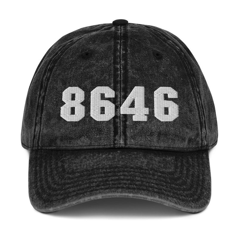 May include: Black vintage baseball cap with the number 8646 embroidered in white on the front.