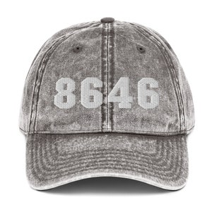 May include: A gray vintage-style baseball cap with the number "8646" embroidered in white on the front.