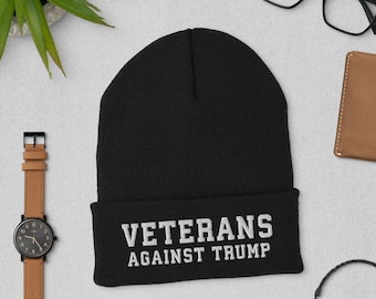 May include: Black beanie with white text that reads "Veterans Against Trump".