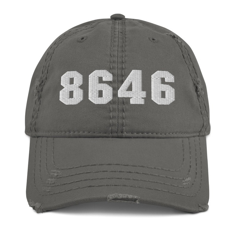 May include: A gray distressed baseball cap with the number 8646 embroidered in white on the front.