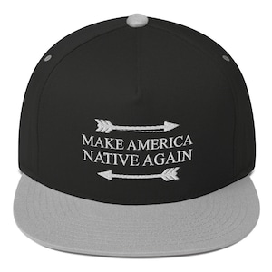 May include: Black and grey baseball cap with the text "Make America Native Again" embroidered in white with two arrows on either side of the text.