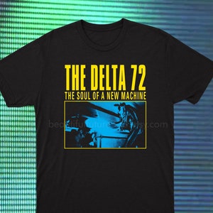 May include: Black t-shirt with yellow text that reads "THE DELTA 72 THE SOUL OF A NEW MACHINE". A blue and black image of a band performing is below the text.