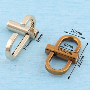 May include: Two metal clasps, one silver and one bronze, with measurements in millimetres. The silver clasp has a hook and a loop, while the bronze clasp has a D-ring shape.