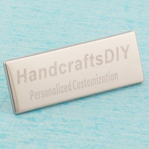 May include: A silver metal rectangular tag with the text "HandcraftsDIY Personalized Customization" engraved on it.