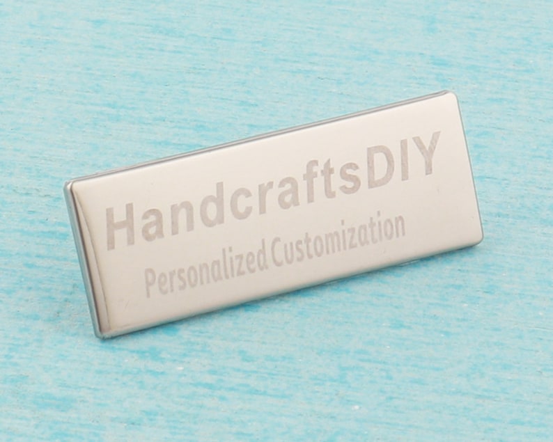May include: A silver metal rectangular tag with the text "HandcraftsDIY Personalized Customization" engraved on it.