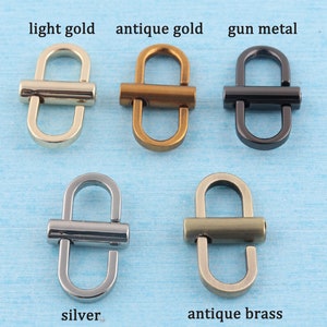 May include: Five metal D-ring clasps in different finishes: light gold, antique gold, gun metal, silver, and antique brass.