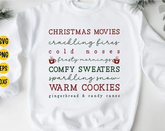 May include: White sweatshirt with text in burgundy and green. The text includes phrases like "Christmas Movies," "Comfy Sweaters," and "Warm Cookies." The design also features coffee cup graphics and the words "gingerbread & candy canes."