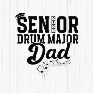 May include: Black and white graphic design with the words "SENIOR 2026 DRUM MAJOR Dad" and a graduation cap icon. Musical notes are at the bottom. The design is on a white wood-grain background.