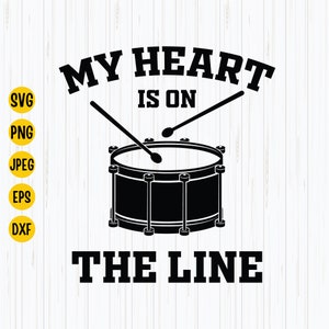 May include: Black and white graphic design with the text "My heart is on the line" and a drum with drumsticks.