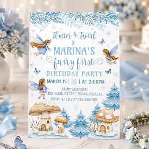 May include: A light blue invitation card for a fairy-themed birthday party. The card features illustrations of fairies, mushrooms, and trees. The text reads "Flutter & Twirl to Marina's fairy first birthday party". The party is on March 15th at 2:00 PM.