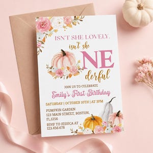 May include: A rectangular birthday invitation card featuring watercolor illustrations of pink and white pumpkins and floral accents. The text reads: ISN'T SHE LOVELY, isn't she ONE derful, JOIN US TO CELEBRATE Emily's First Birthday, and event details.